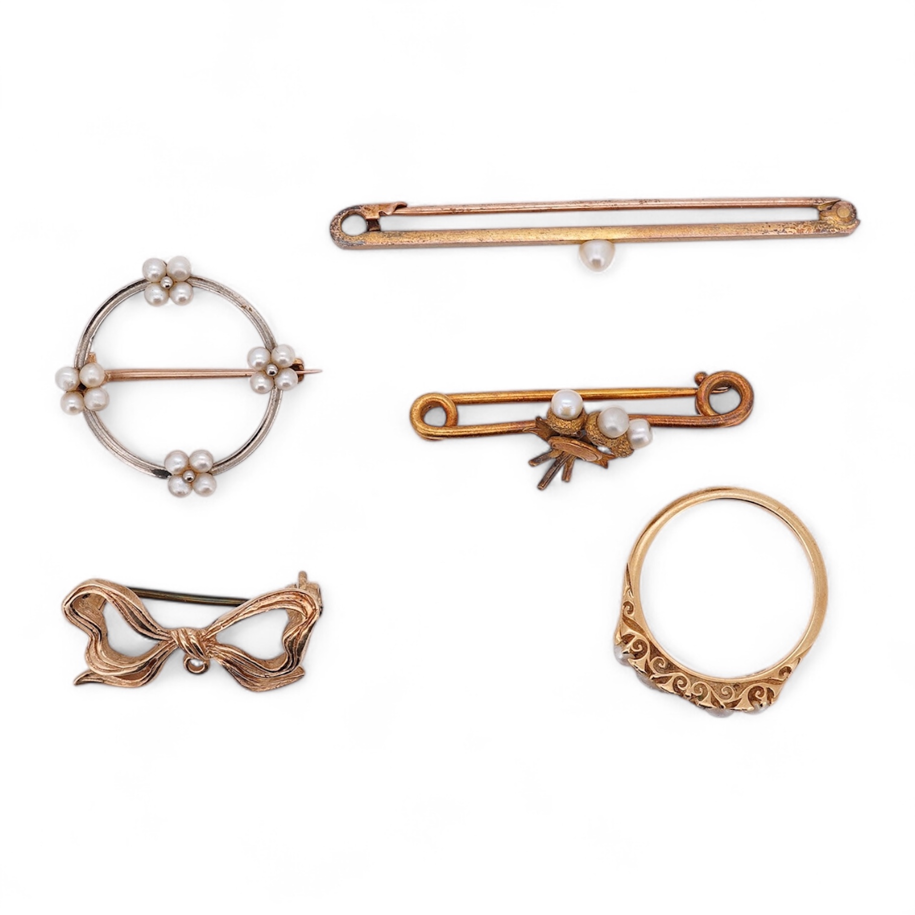 Five assorted items of jewellery including an early 20th century yellow metal and seed pearl set acorn bar brooch, 31mm, a similar yellow metal and split pearl ring ring (one missing), with diamond chip spacers, a modern